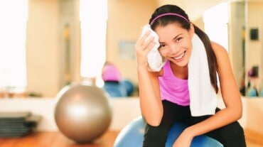 Woman wiping off sweat during workout